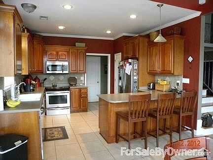 Kitchen
						:
						Custom cherry cabinets, tile floors and backsplash. New stainless appliances.