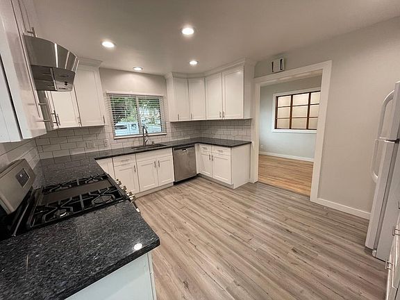 Newly remodeled kitchen with gas stove and dishwasher.