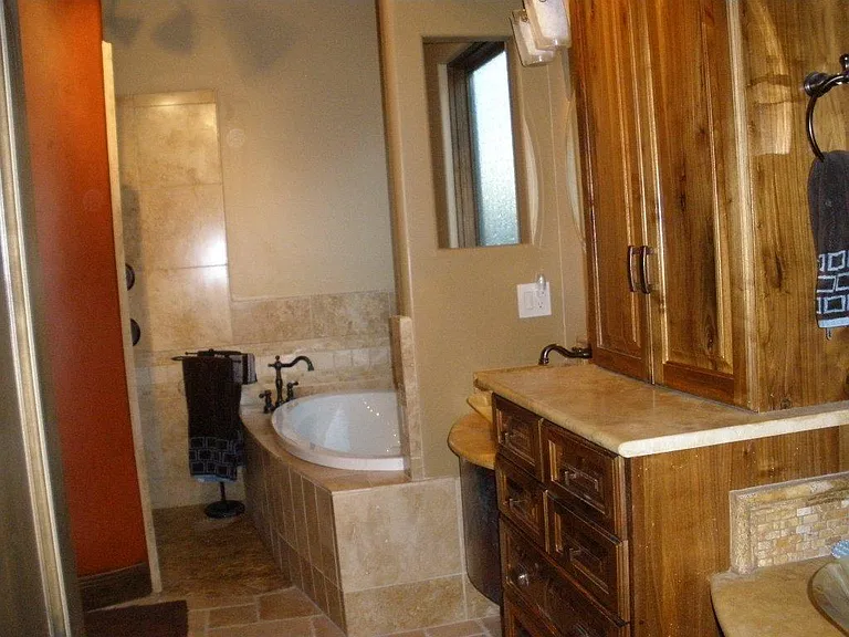 another view of master bash - double sinks, tub and shower. Plus, large walk in closet