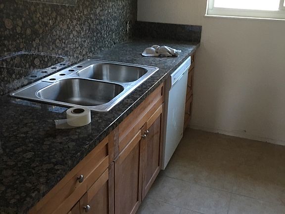 Picture of new cabinets and granite counter. Actual kitchen has faucet and garbage disposal.