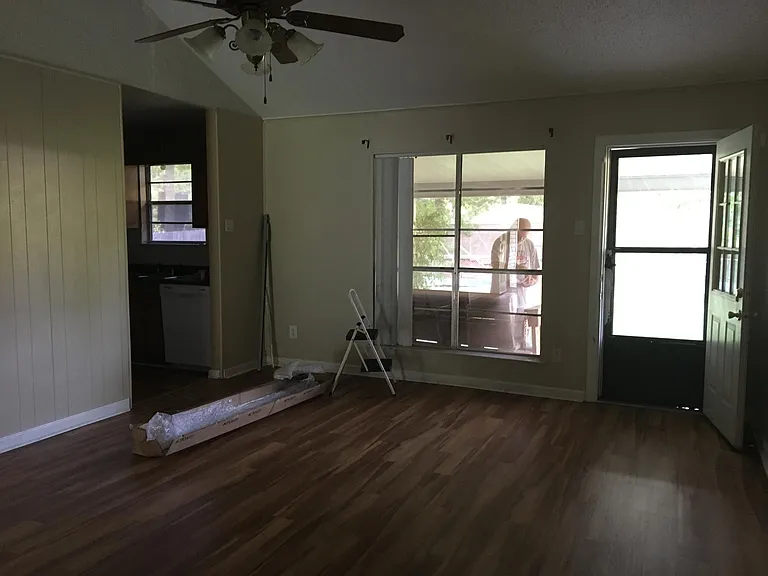 Livingroom towards back, new blinds being put up.