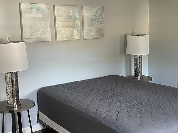 Bedroom number two has a queen size bed and a smart TV and a large closet.