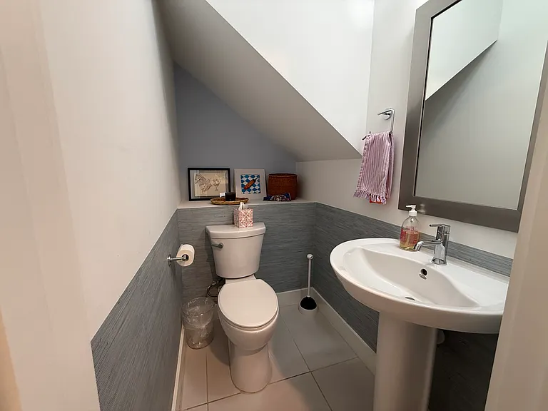 Half-bathroom located in the entryway on the first floor.