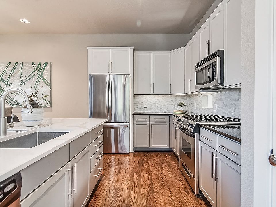 Two tone kitchen cabinets and marble backsplash