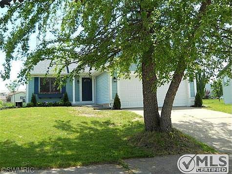 Exterior has been updated with a new garage door, front door, shutters, window box and new light fixtures