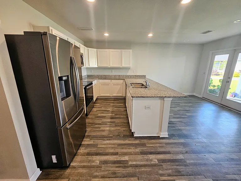 View of the kitchen from the laundry room hallway