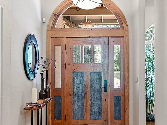 The entry is anchored by the custom "Real Carriage Doors" front door that greets you and your guests every day.>