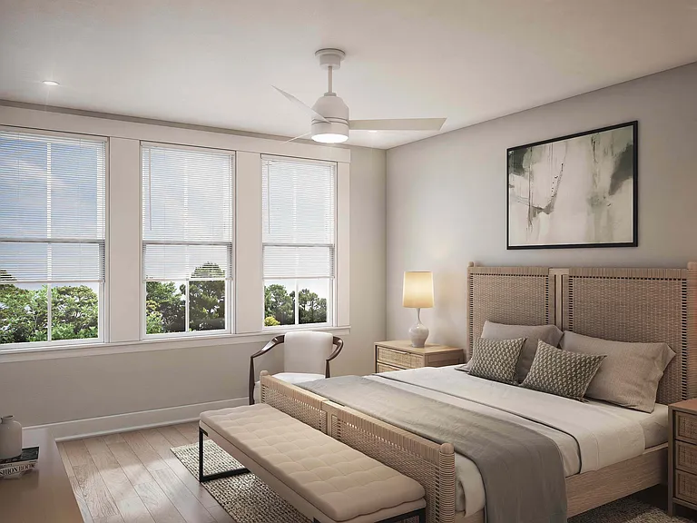 The primary bedroom at Fenland Townhomes offers a serene retreat with an expansive walk-in closet and en suite bathroom