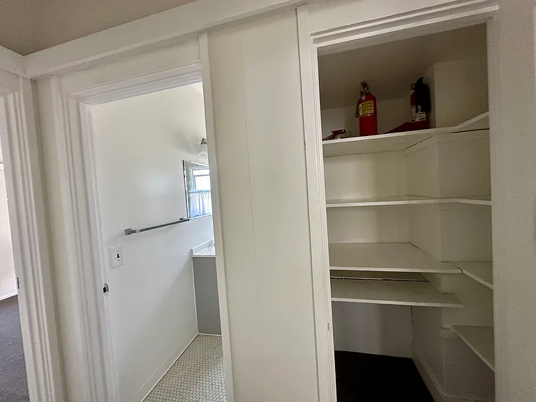 Back hallway with hall closet and bathroom