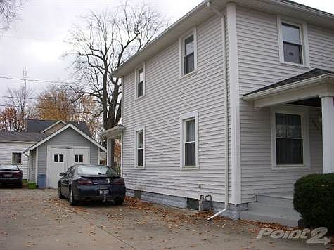 Cement drive with detached garagae.