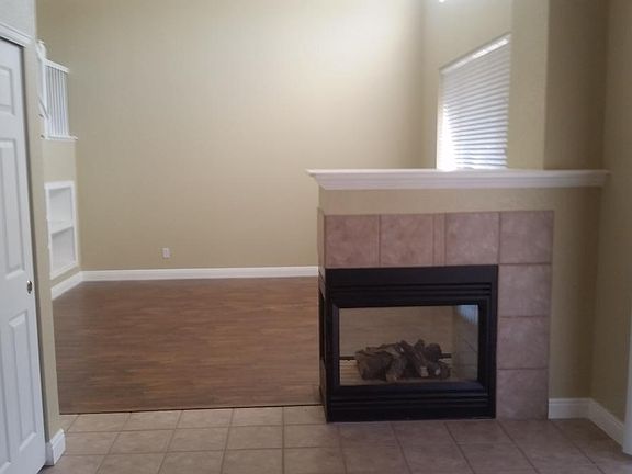 Living room and fireplace which separates the dining area fr