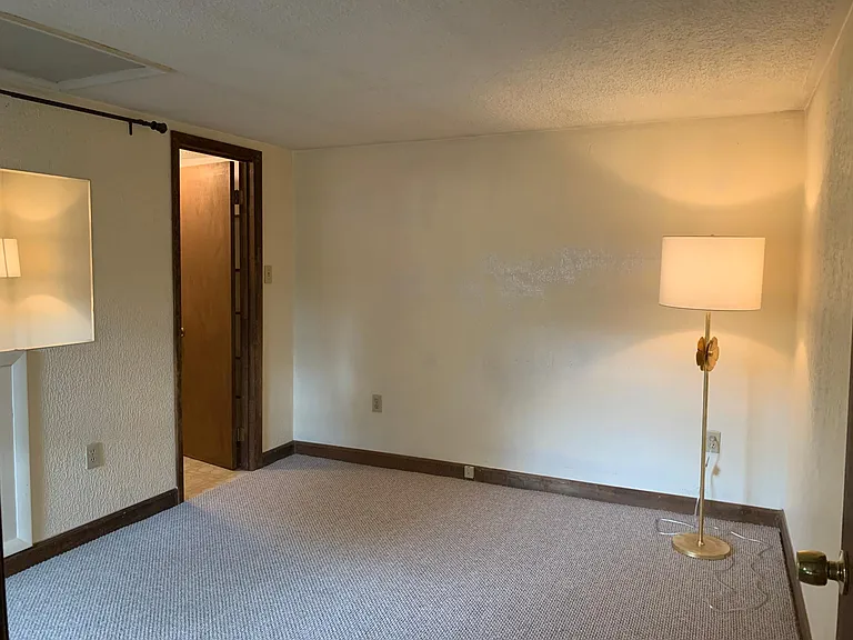 Upstairs master suite: bedroom, with walk-in closet and tiled-floor full bath. Room comfortably fits a queen-sized bed with a bedside table.