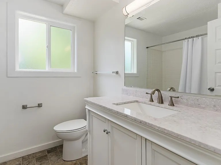 Cheerful Bath with Newer Screened Window; New Fooring, Toilet, Handsome New Vanity w Sink & Faucet, Attractive Large Mirror. NICE
& Pristine