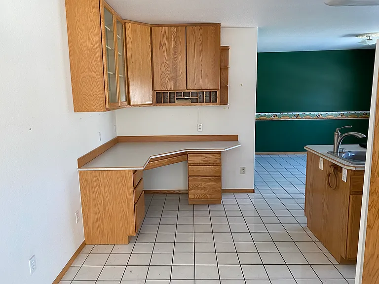 Moving into the kitchen. Great kitchen desk or study space, or perfect for a bar or coffee nook. Breakfast area for a casual table and chair in the back.