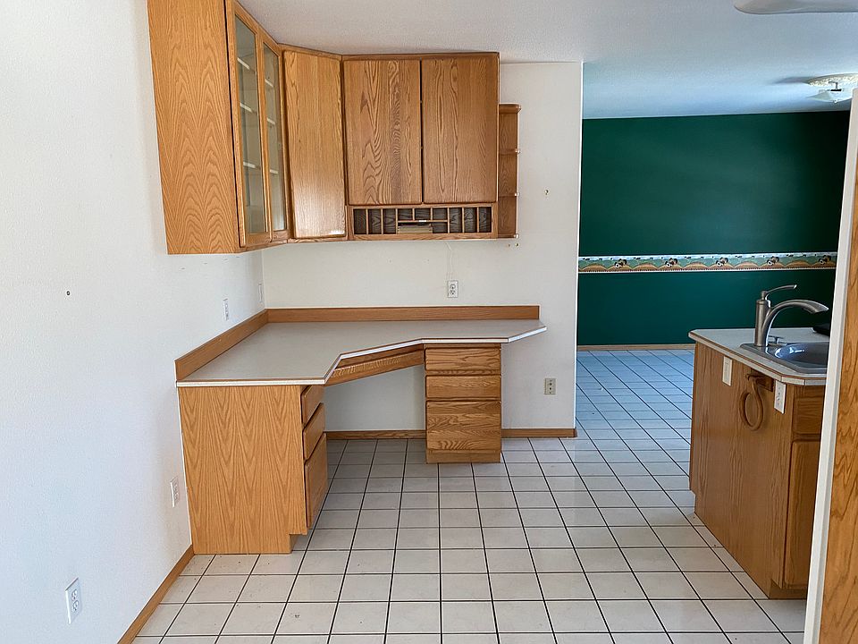Moving into the kitchen. Great kitchen desk or study space, or perfect for a bar or coffee nook. Breakfast area for a casual table and chair in the back.