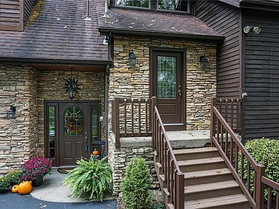 Stone detailing greets guests at either entrance of this custom built home.