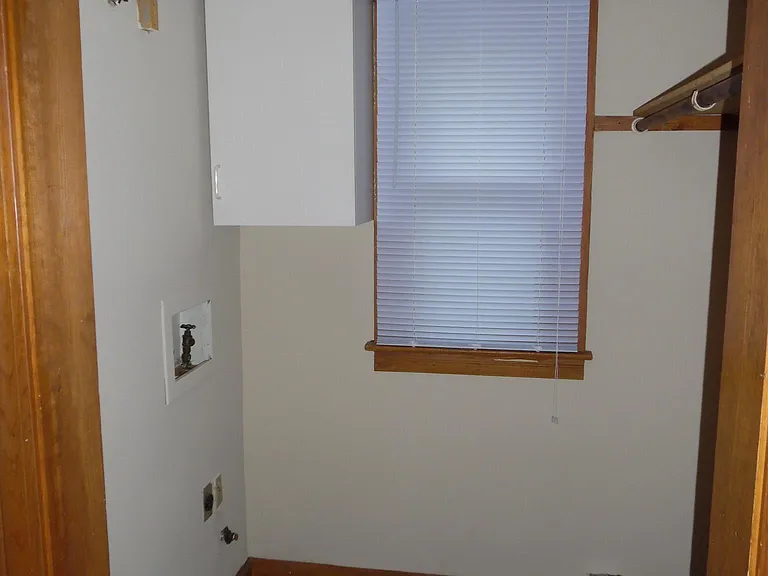 Off living room coming into the kitchen is the utility room with washer and dryer hookups. 5'6" x 5'4"