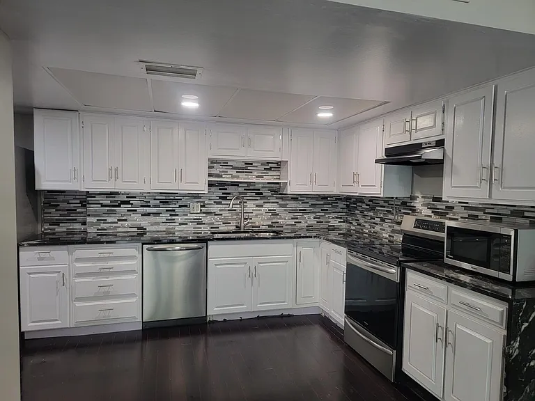 Kitchen with granite counter tops, back splash