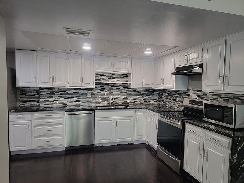 Kitchen with granite counter tops, back splash