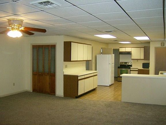 View of coat closet and kitchen from west side of living roo