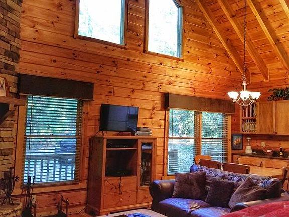 Living and dining room with vaulted ceiling.