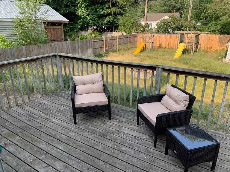 Private, quiet, back deck and fenced in backyard with play set with slides and swings.