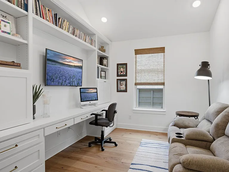 The owners added these beautiful wall-to-wall custom built-ins in the flex space. Ideal for those who work from home. Makes a great den or craft room too.