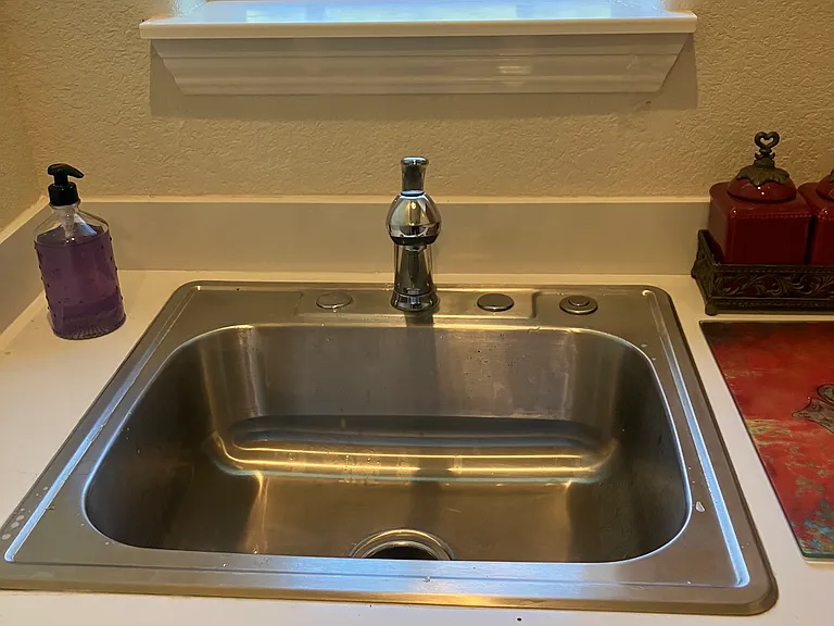 The laundry room has a full sink with a garbage disposal.