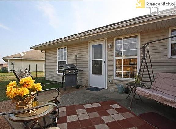 this adorable back porch area is like having your very own outside living room