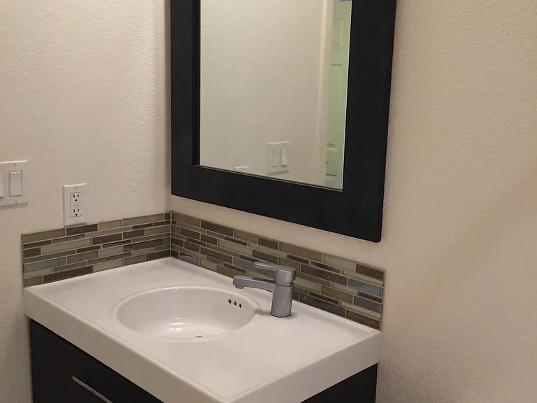 Renovated bathroom with lots of under-counter storage.