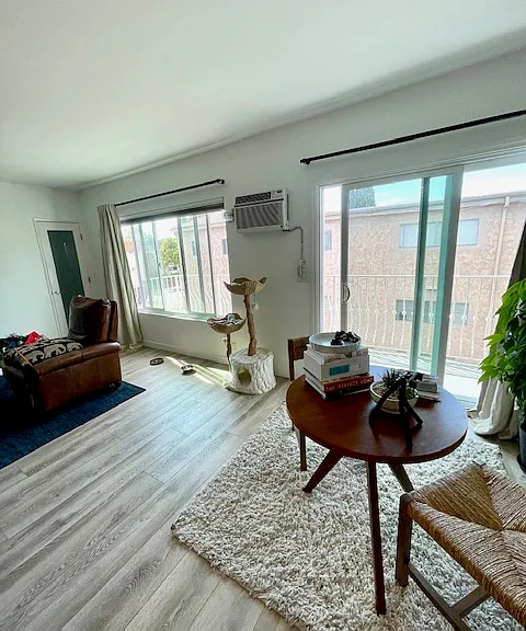 Living room and dining room next to large balcony with sliding doors