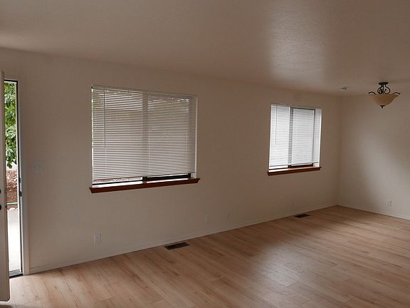 Morning light filters through the living room windows onto the Inhaus Lamdura Landmark laminate flooring.