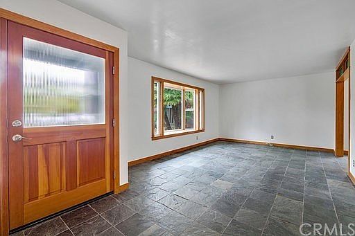 Beautiful wood and glass doors, Bay window, slate flooring in this spacious living room