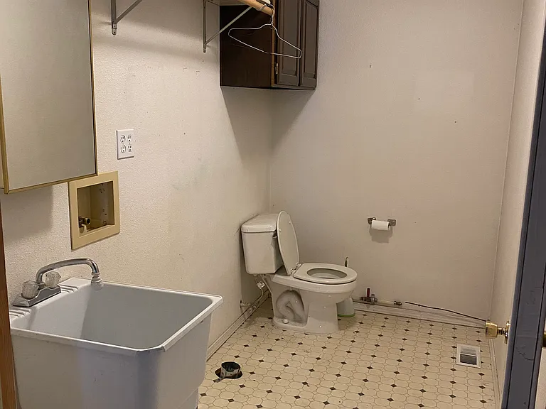 Off the garage is the utility room with a utility sink, WD Hookups and a half bath.