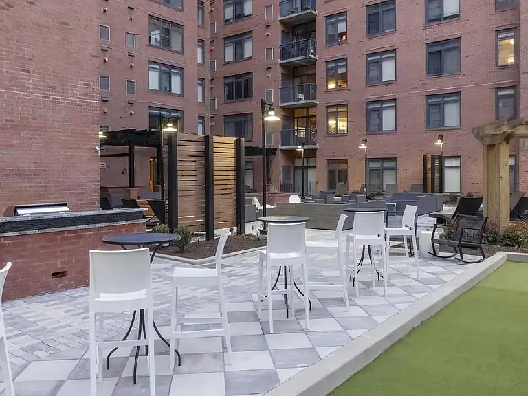 Courtyard With Bar Seating, Grill Station, and Lounge Areas