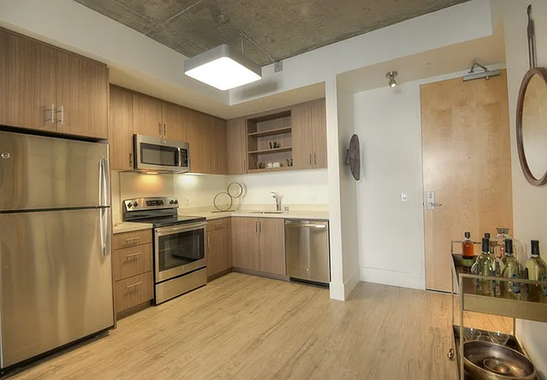 Stylish kitchen with stainless steel appliances and quartz countertops