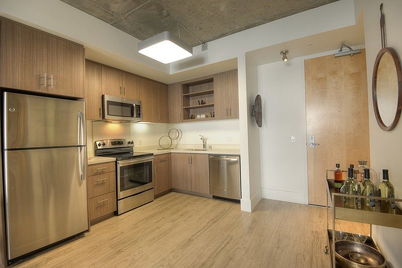 Stylish kitchen with stainless steel appliances and quartz countertops