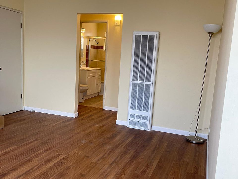 The living room has a closet and new flooring. The unit is freshly painted throughout.