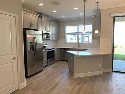 Kitchen complete with stainless steel appliances, quartz countertops and breakfast bar
