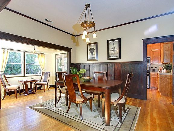 The dining area with wood stained wainscoting.