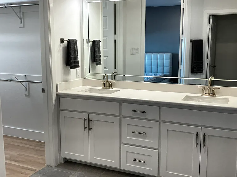 primary en-suite double vanities, well-lit