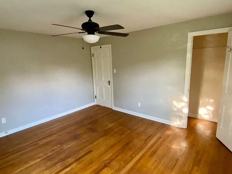 2nd bedroom with hardwood floor and ceiling fan