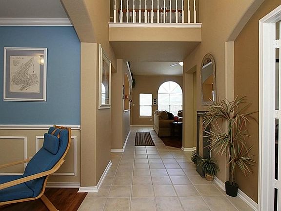 View from tiled entry hall leading to 2-story den