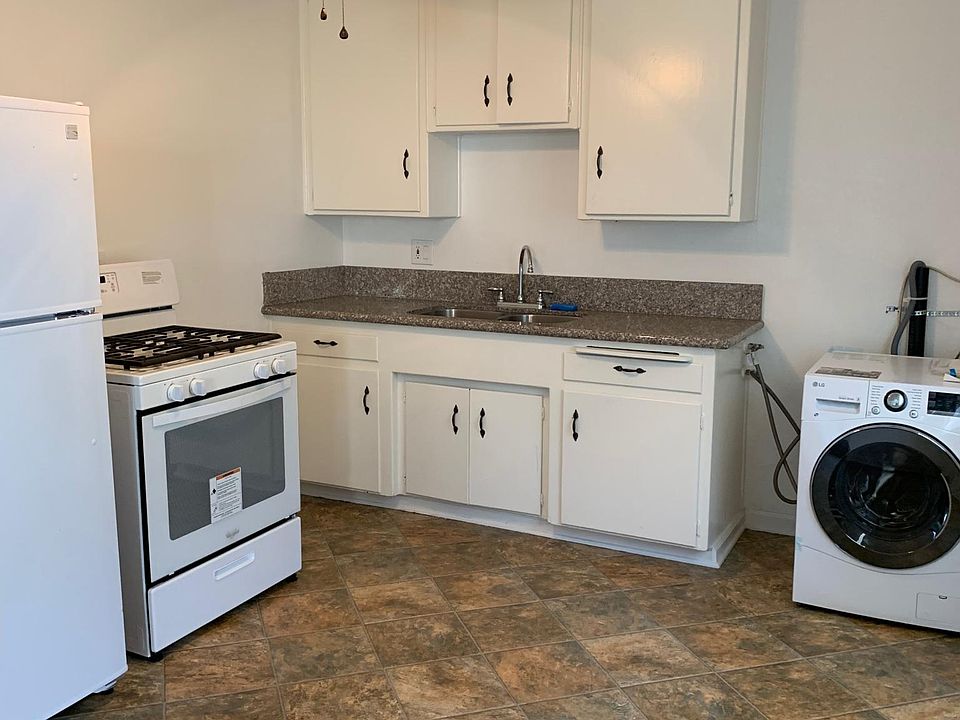 Kitchen includes Refrigerator, stove, and washer dryer combo