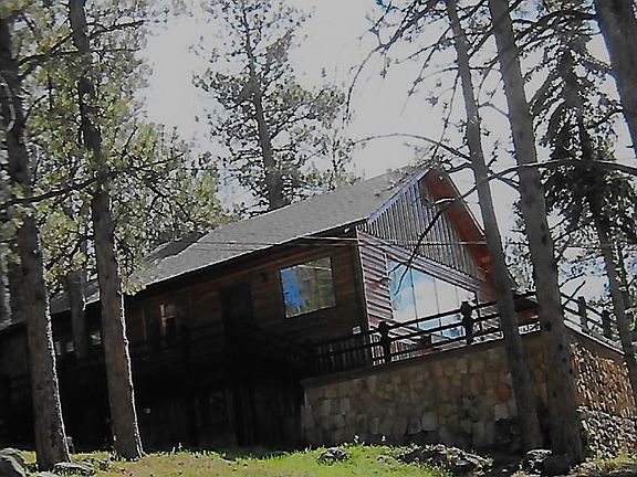 Side view, and front of the house with the deck