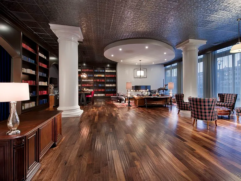 Resident lounge library room with fireplaces and seating