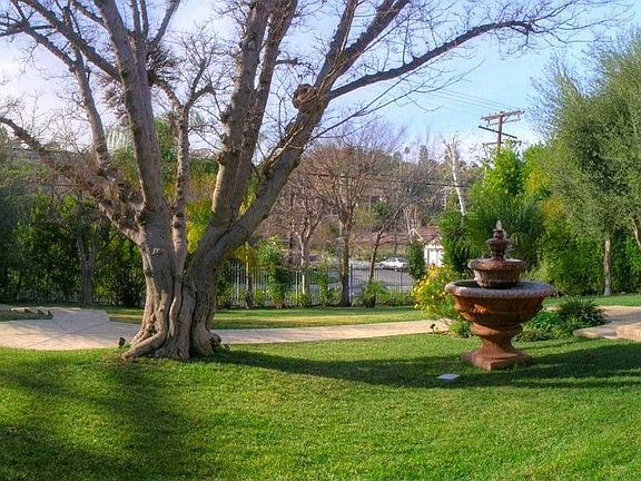 Park-Like Lush Green Grounds, Serene Fountains, Towering Oak Trees.