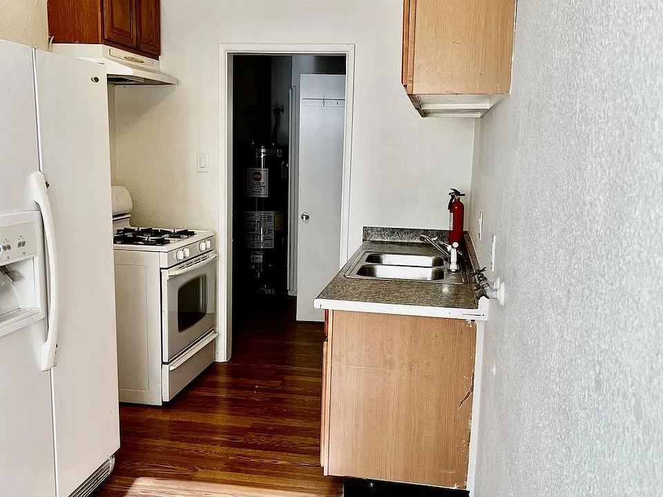 Alley kitchen with nice size refrigerator