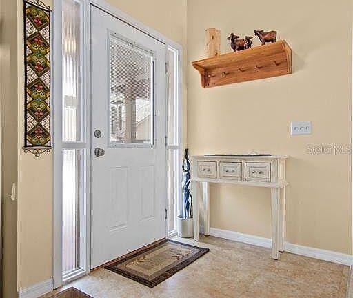 Spacious entry-decorated by a previous renter. There's a step down into the living room, and straight ahead, you walk into the open dining room, patio and kitchen area.