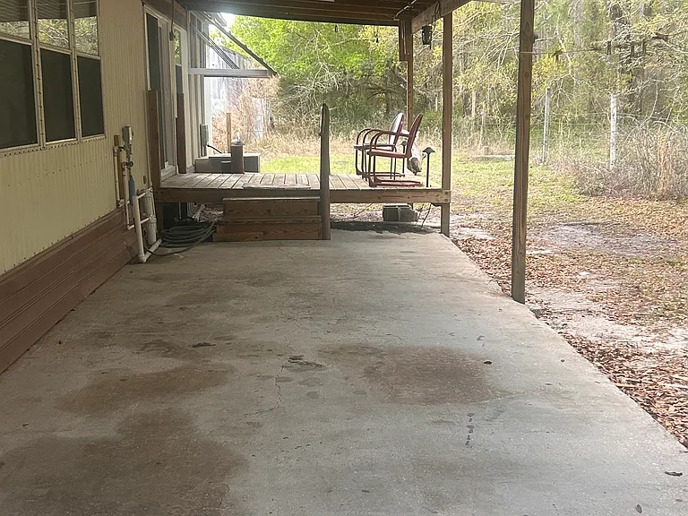 Attached carport and back deck at kitchen entry